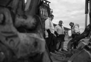 Team Looking at Excavator